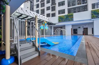 a swimming pool in a building with a slide at Skyline Kuala Lumpur near Lalaport by Cityscape in Kuala Lumpur