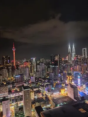 a city skyline at night with a lot of buildings at Elements apartment service at Times Square in Kuala Lumpur