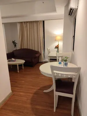 a living room with a table and a couch at Elements apartment service at Times Square in Kuala Lumpur