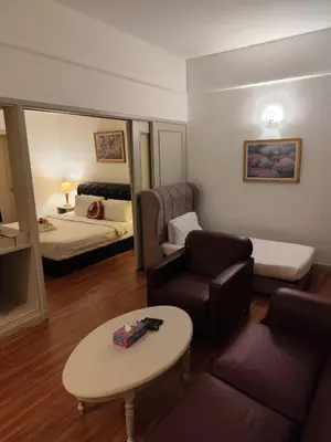 a living room with a couch and a bed and a table at Elements apartment service at Times Square in Kuala Lumpur