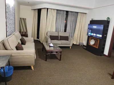 a living room with two couches and a tv at Time Square Mountain View Apartment KL in Kuala Lumpur