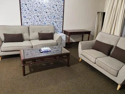 a living room with two couches and a coffee table at Time Square Mountain View Apartment KL in Kuala Lumpur