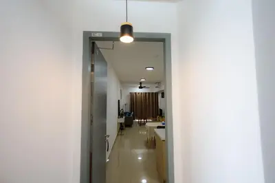 a hallway leading into a kitchen with a light fixture at M Arisa Sentul by A&T in Kuala Lumpur