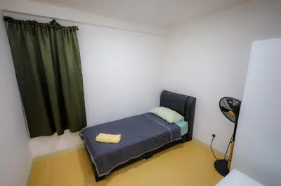 a small bedroom with a bed and a window at M Arisa Sentul by A&T in Kuala Lumpur