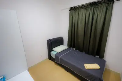 a small bed in a room with a window at M Arisa Sentul by A&T in Kuala Lumpur