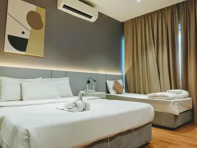 two beds in a hotel room with swans on them at Victoria Suites Quill Residence KLCC in Kuala Lumpur