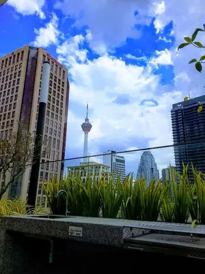 a view of a city with tall buildings and plants at Victoria Suites Quill Residence KLCC in Kuala Lumpur