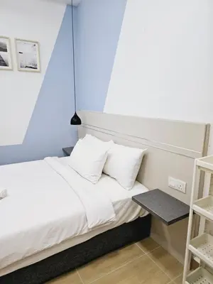 a bed with white sheets and pillows in a room at Infinitum suites KLCC Sky Pool by EXA in Kuala Lumpur