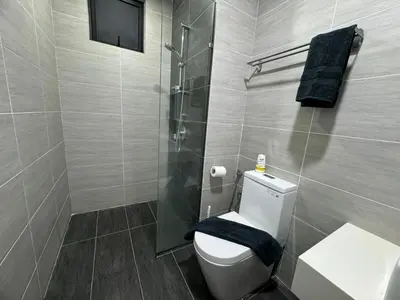 a bathroom with a toilet and a glass shower at TRION KL, Jalan Chan Sow Lin, Kuala Lumpur in Kuala Lumpur