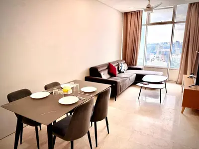 a living room with a table and a couch at Sky suites klcc by Aisyah in Kuala Lumpur
