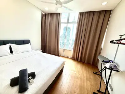 a bedroom with a white bed and a large window at Sky suites klcc by Aisyah in Kuala Lumpur