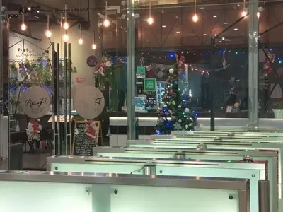 a christmas tree in the middle of a group of pews at Binjai 8 KLCC BY Service Suites in Kuala Lumpur