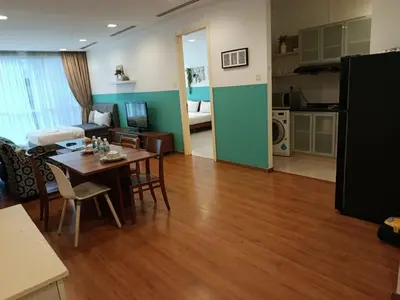 a living room with a dining table and a kitchen at Binjai 8 KLCC BY Service Suites in Kuala Lumpur