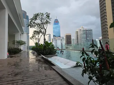 a pool in a building with a view of a city at Aurelia Suites Quill Residences in Kuala Lumpur