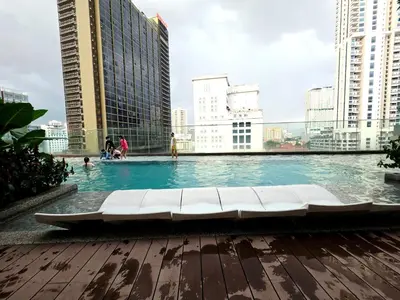 a swimming pool in a city with tall buildings at Aurelia Suites Quill Residences in Kuala Lumpur