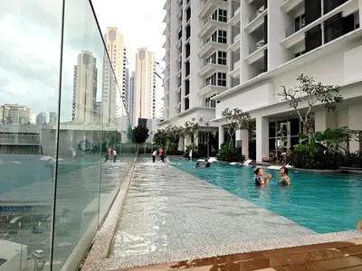 people swimming in a swimming pool in a building at Aurelia Suites Quill Residences in Kuala Lumpur