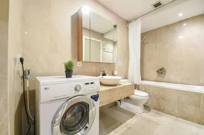 a bathroom with a washing machine and a sink at Fairlane Residence near Bukit Bintang KL in Kuala Lumpur