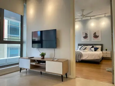 a living room with a tv and a bed at Fairlane Residence near Bukit Bintang KL in Kuala Lumpur