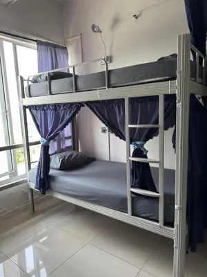 a bedroom with two bunk beds in a room at TikiiBunk Packers in Kuala Lumpur