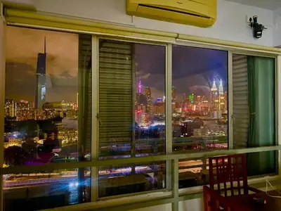 a view of a city skyline from a window at TikiiBunk Packers in Kuala Lumpur
