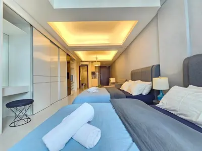 a bedroom with two beds and a room with at Cozy Suites 2 to 5pax near Sri Hartamas Mont Kiara in Kuala Lumpur