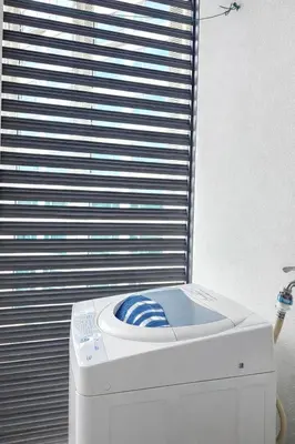 a washing machine sitting in front of a window at Cozy Suites 2 to 5pax near Sri Hartamas Mont Kiara in Kuala Lumpur