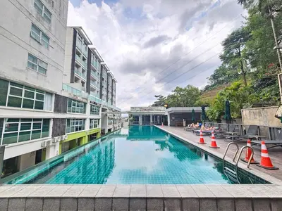 a large swimming pool next to a building at Cozy Suites 2 to 5pax near Sri Hartamas Mont Kiara in Kuala Lumpur