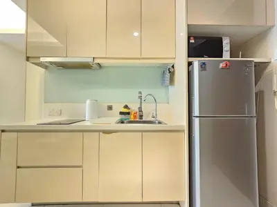 a kitchen with a refrigerator and a sink at Cozy Suites 2 to 5pax near Sri Hartamas Mont Kiara in Kuala Lumpur