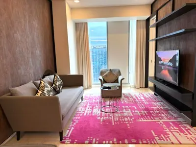 a living room with a couch and a tv at Tropicana Residences CoolStay in Kuala Lumpur