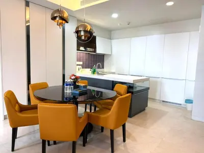a kitchen with a black table and yellow chairs at Tropicana Residences CoolStay in Kuala Lumpur