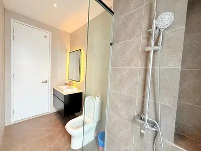 a bathroom with a shower and a toilet and a sink at Axon Residence KL Luxury Bukit Bintang in Kuala Lumpur