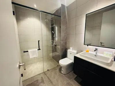 a bathroom with a shower and a toilet and a sink at Axon Residence KL Luxury Bukit Bintang in Kuala Lumpur