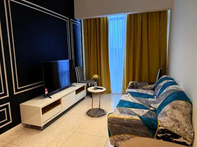 a living room with a couch and a flat screen tv at Axon Residence KL Luxury Bukit Bintang in Kuala Lumpur