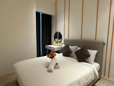 a bedroom with a large white bed with a mirror at Axon Residence KL Luxury Bukit Bintang in Kuala Lumpur