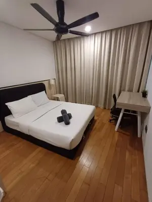 a bedroom with a bed and a ceiling fan at Klcc vortex suites by comfort stay in Kuala Lumpur