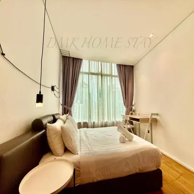 a bedroom with a bed with a welcome sign on the wall at Klcc vortex suites by comfort stay in Kuala Lumpur