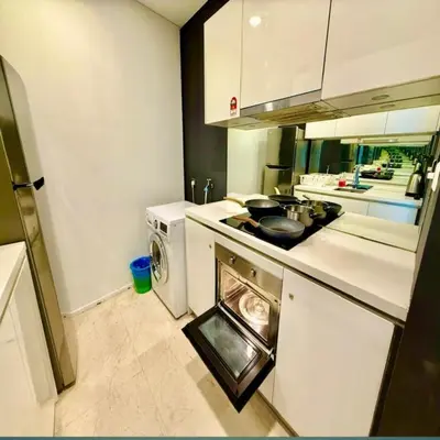 a kitchen with a stove and a washing machine at Klcc vortex suites by comfort stay in Kuala Lumpur