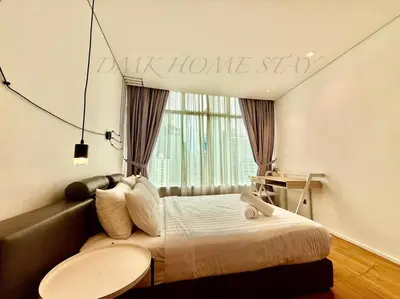 a bedroom with a bed with a welcome sign on the wall at Klcc vortex suites by comfort stay in Kuala Lumpur