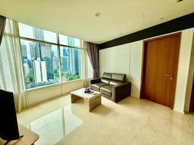 a living room with a couch and a large window at Klcc vortex suites by comfort stay in Kuala Lumpur