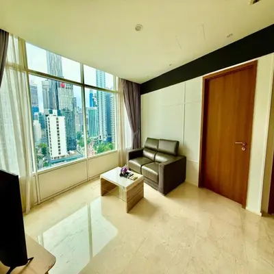 a living room with a couch and a large window at Klcc vortex suites by comfort stay in Kuala Lumpur