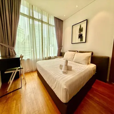 a bedroom with a large bed and a window at Klcc vortex suites by comfort stay in Kuala Lumpur