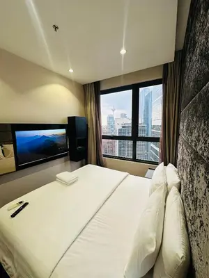 a bedroom with a large bed with a large window at City towen klcc by TTR in Kuala Lumpur