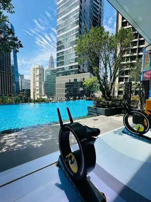 a pair of headphones sitting on a table with a view of a city at City towen klcc by TTR in Kuala Lumpur