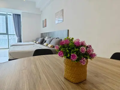a vase with purple flowers on a table in a bedroom at 02 Kuala Lumpur KL Mid Valley The Garden 9Seputeh Vivo Soho 4PAX in Kuala Lumpur