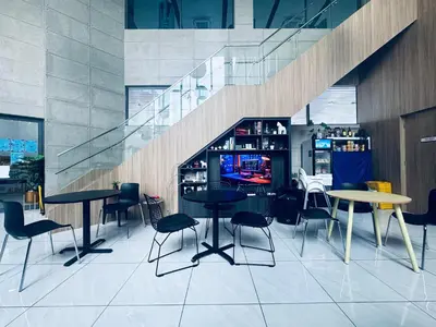 a restaurant with tables and chairs and a staircase at The luxe klcc by jaurami stay in Kuala Lumpur