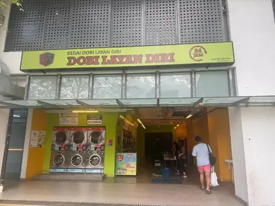 a man standing in front of a donut shop at The luxe klcc by jaurami stay in Kuala Lumpur