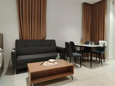 a living room with a couch and a table at NEO Quill Residences klcc in Kuala Lumpur