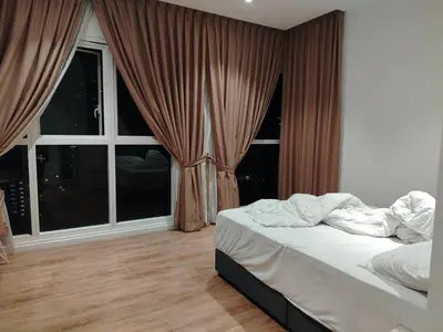 a bedroom with a bed and a large window at NEO Quill Residences klcc in Kuala Lumpur