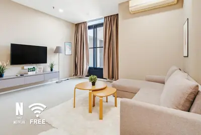 a living room with a couch and a table at Arcoris SOHO Mont Kiara , Stylish 1 Bedroom Retreat in Kuala Lumpur