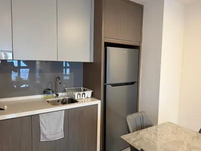 a kitchen with a sink and a refrigerator at Bukit Bintang Suites KLCC by YBS in Kuala Lumpur